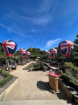 Union flag hot air balloons sat around outside dining arrangments
