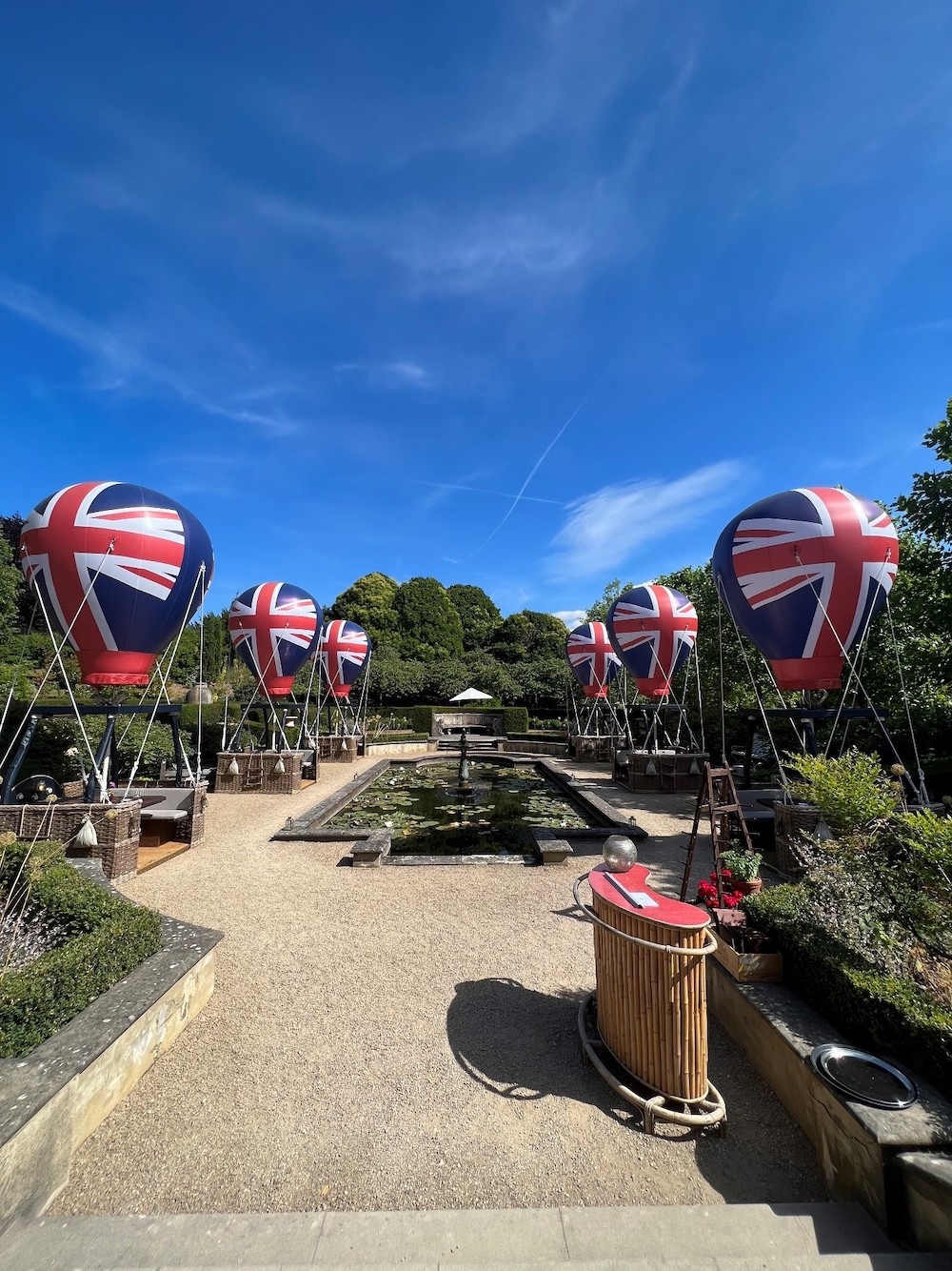 Union flag hot air balloons sat amongst outside dining