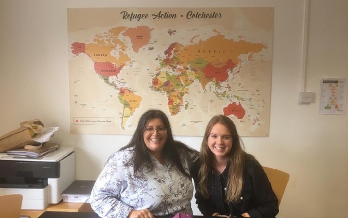 photo of Maria Wilby and Mackenzie Robinson in the offices of Refugee Action Colchester