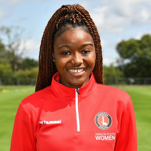 University of Essex Alumna Teni Charles portrait photo featured in a red Charlton Athletic women's football team kit smiling to the camera
