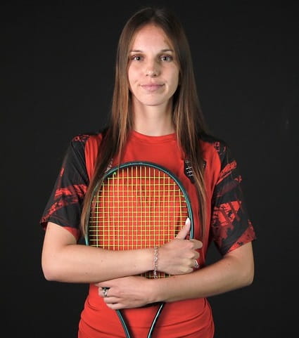 Profile image of University of Essex tennis scholar Alexandra Dodashev Enbert in Essex Blades training kit holding her tennis racket