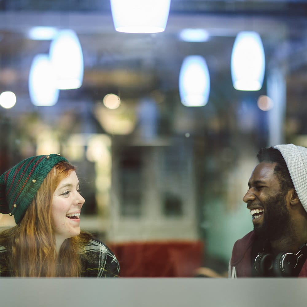 Two students talking in the SU Bar at our Southend Campus