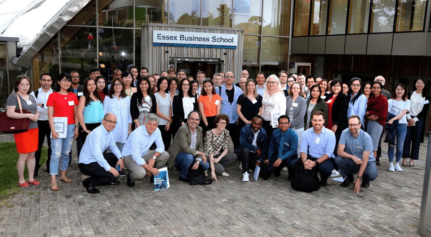 Group photo of academics outside the front of the Essex Business School in Colchester