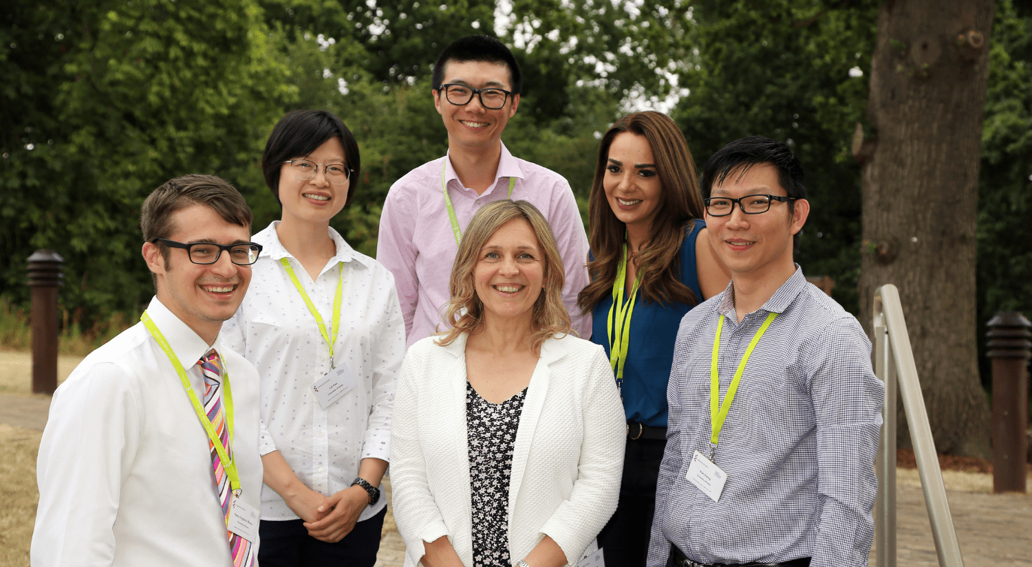 A group photo of five academics. Photo is taken outside and academics are looking at the camera