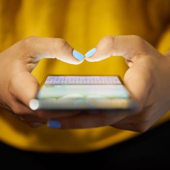 A person holding a phone contacting the University of Essex about Clearing.