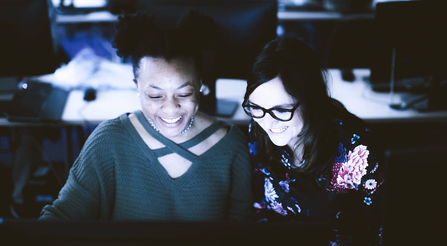 A member of staff supporting a student in one of our computer labs