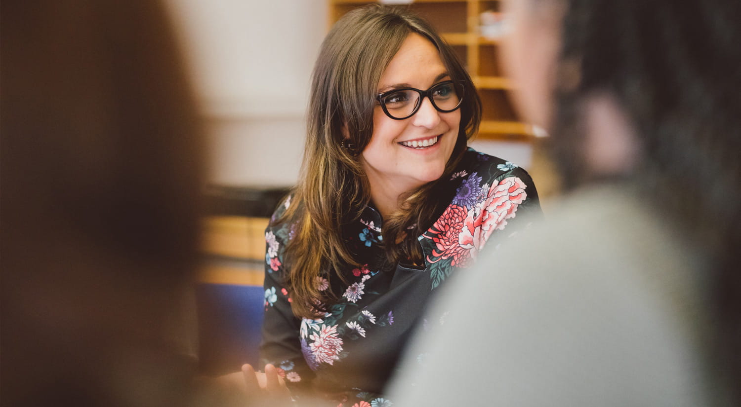 Image of a member of staff working with other students