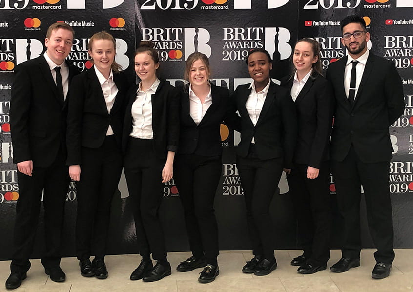 Students of the Edge Hotel School pose at the BRIT Awards