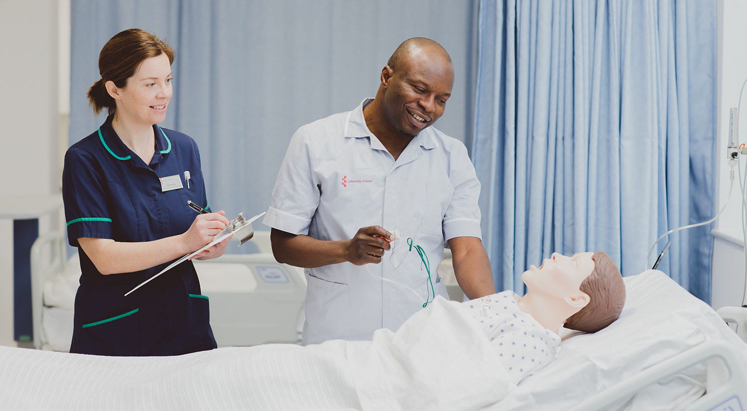 A nursing student practising assessing a training manikin