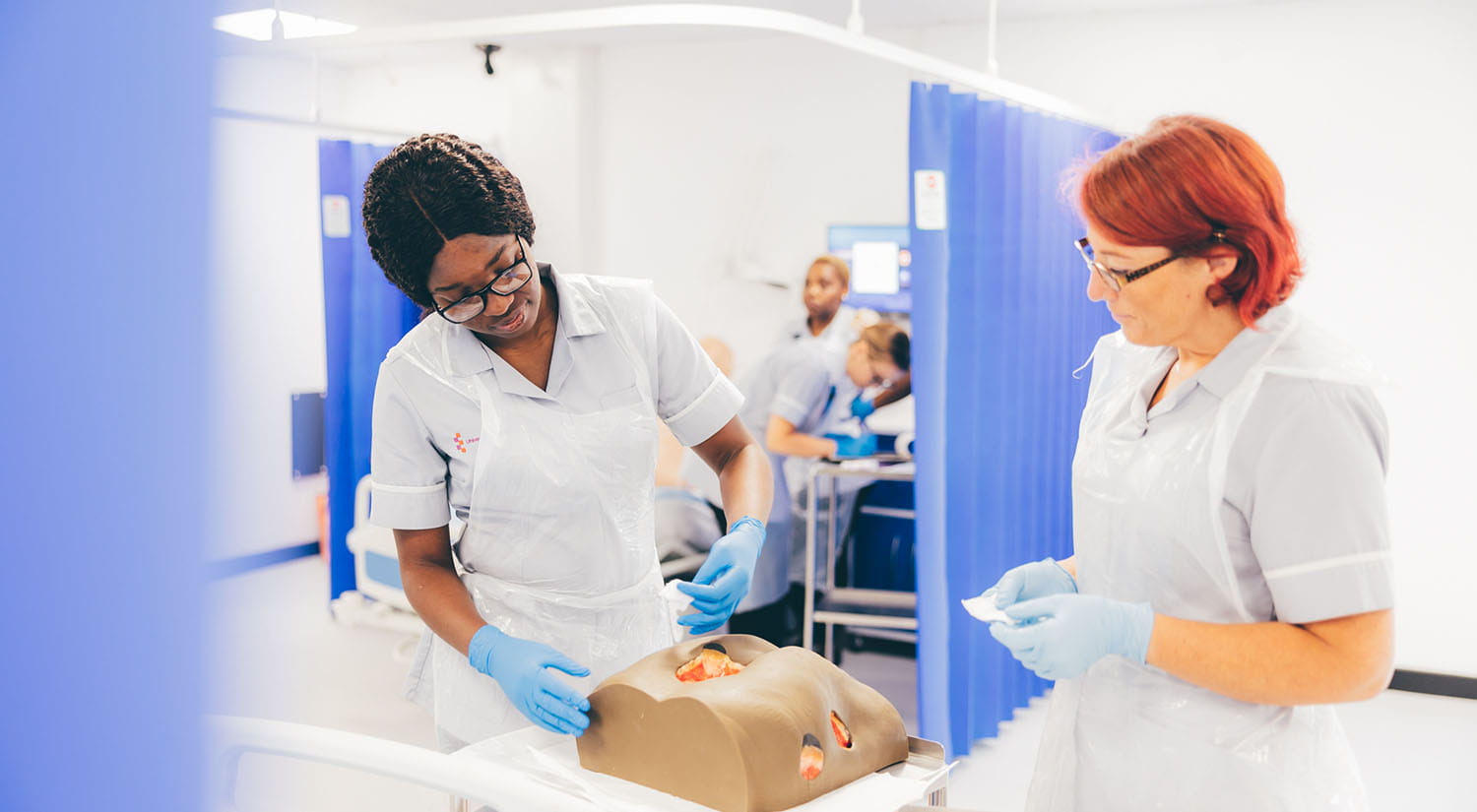 Nursing students practising wound care