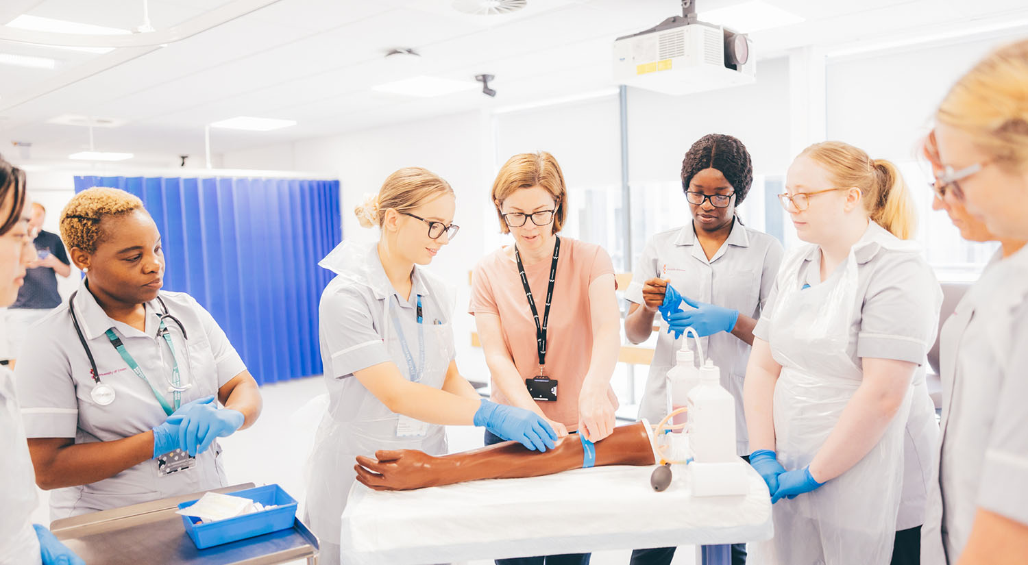 Nursing students practising taking blood specimens