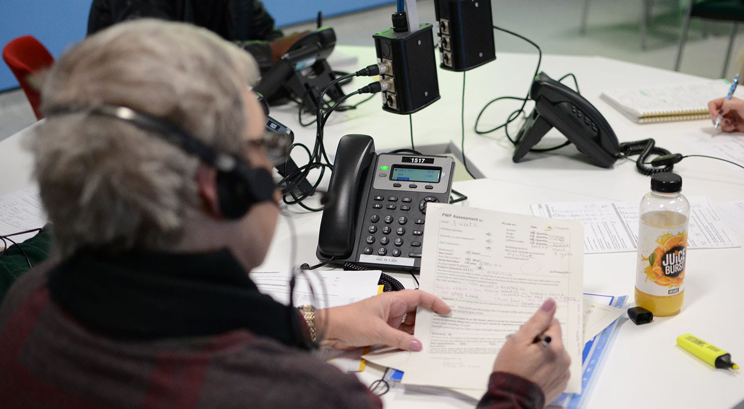 A PWP student making notes whilst on a mock call