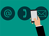 An illustration of a hand holding a phone in front of email and telephone logos