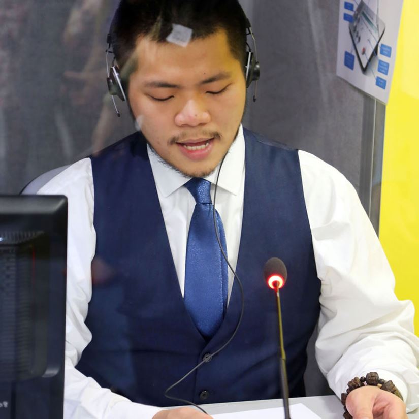 student translating in a booth