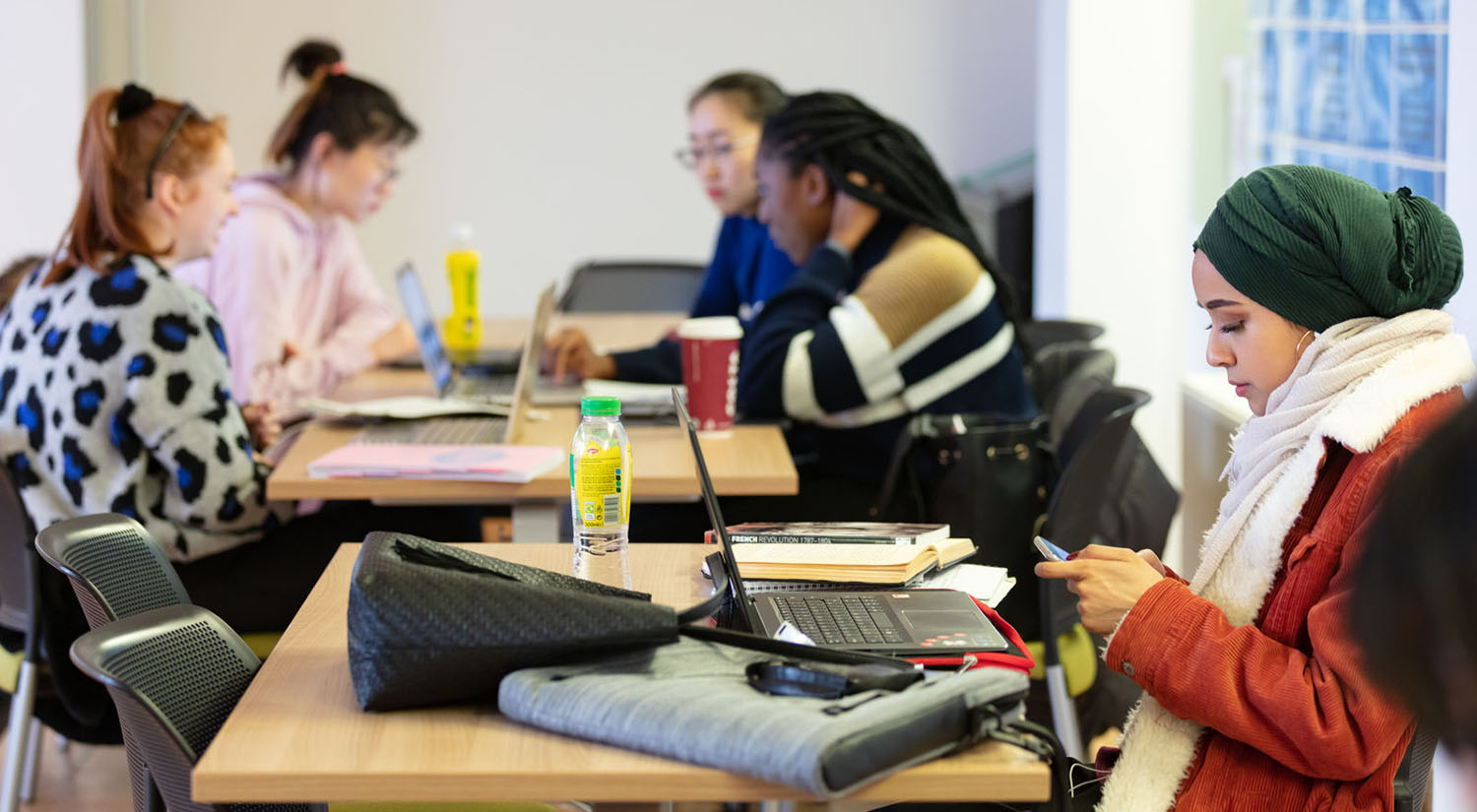 Group of students sitting at classroom desks studying