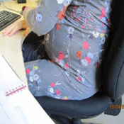 Pregnant woman sitting at desk