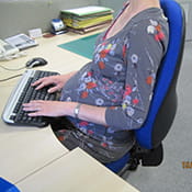 Pregnant woman sitting at desk