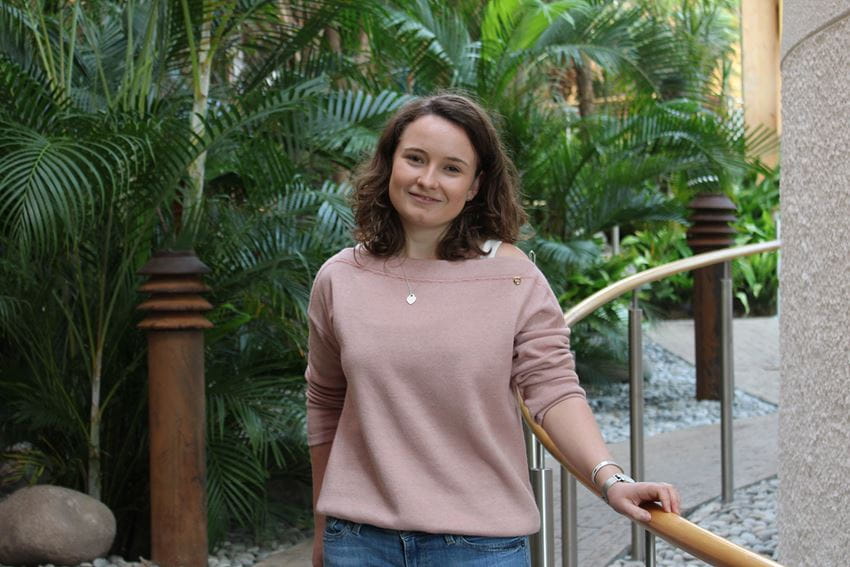 BSc Banking and Finance Student Dorota Hotova stands in the Essex Business School Winter Garden wearing a light pink jumper.