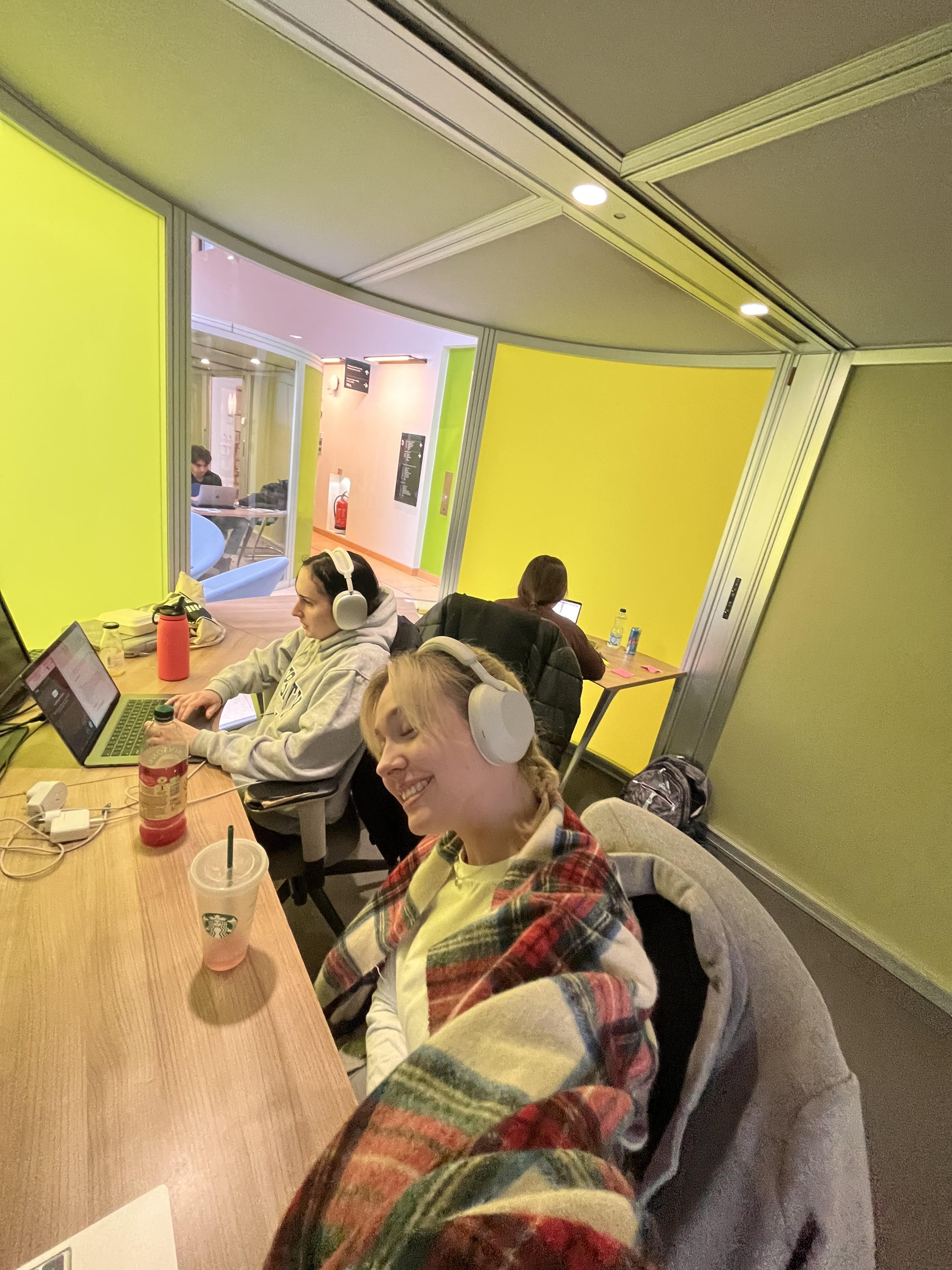 Luisa and a friend studying on laptops 