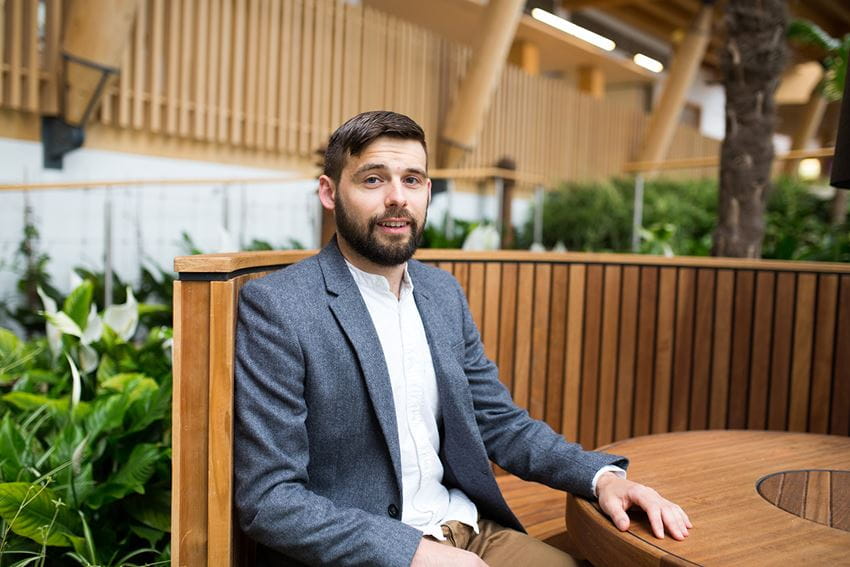 Dr Stephen Murphy, Lecturer in MAnagement and Marketing at Essex Business School, sits in the winter garden.