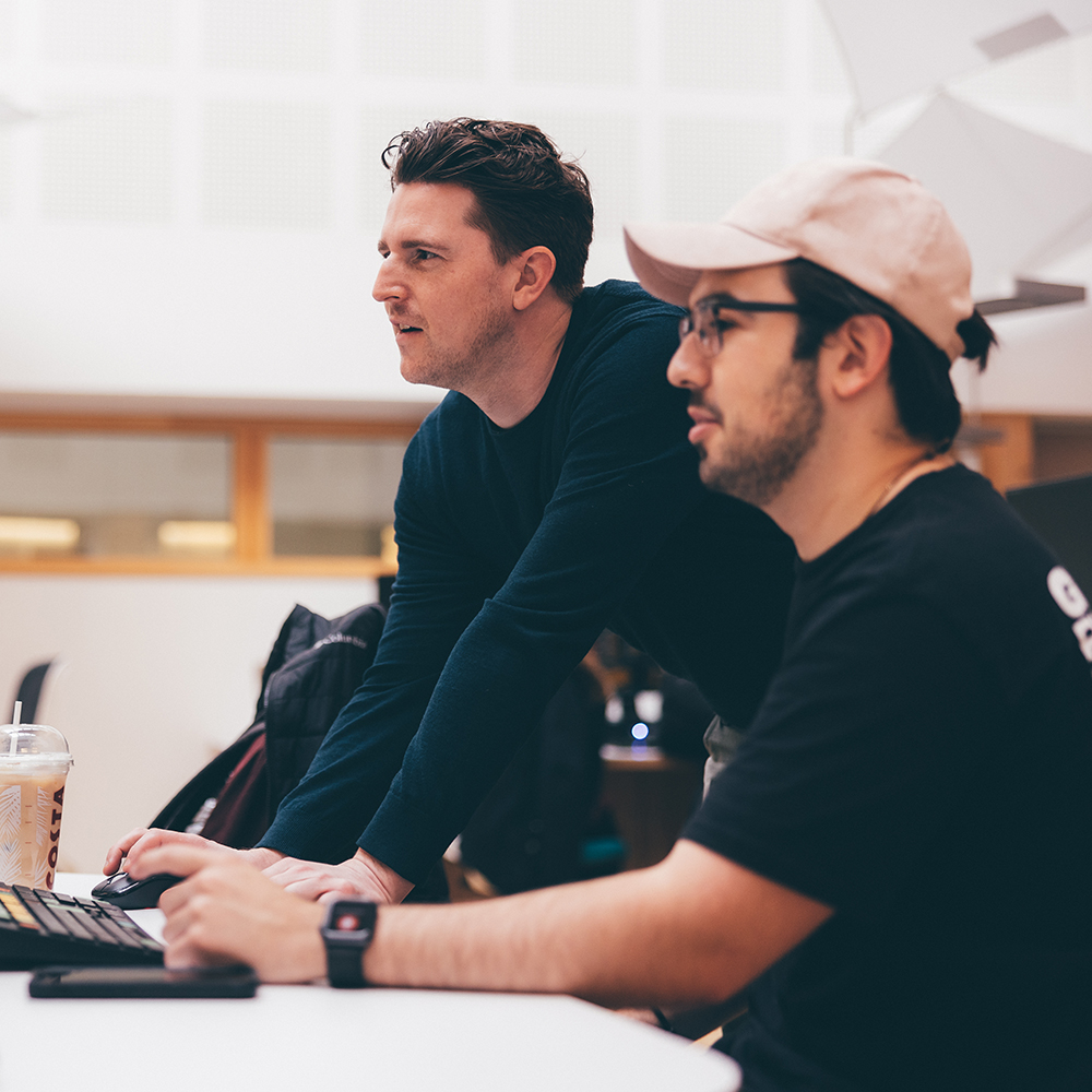Dr Lorcan Whitehead, Essex Business School Learning and Teaching Advisor, supports a student at one of the Bloomberg terminals in the business school's virtual trading floor.