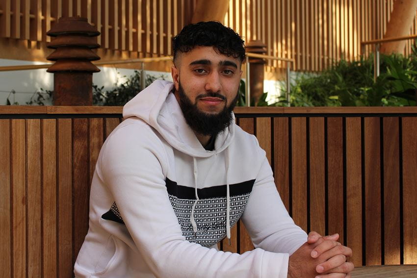 BSc Accounting and Finance student, Suraj Chadha, sits in the Essex Business School winter garden