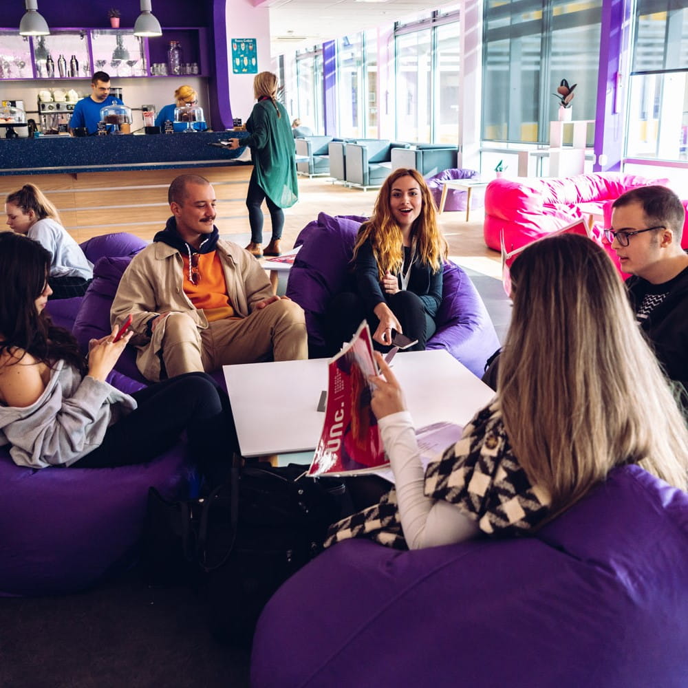 A group of students sitting in bean bags socialising together