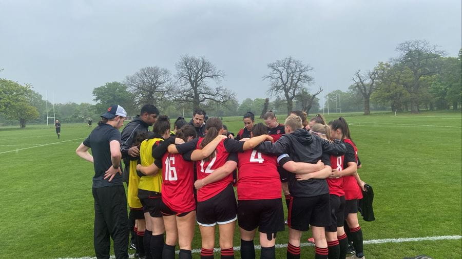 UoE Women's Football team in a pre-game huddle