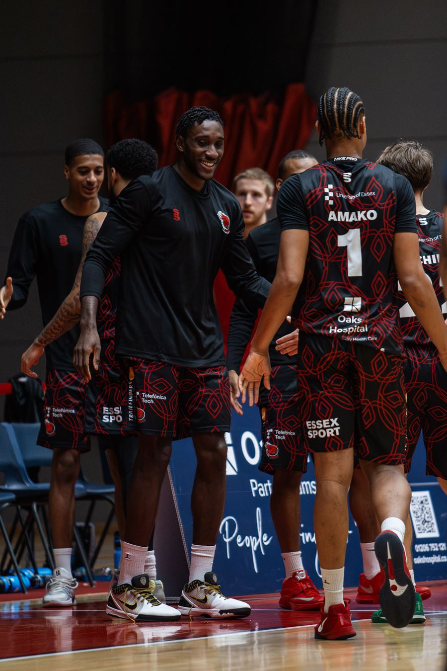Basketball players talking to one another at the sidelines of a game