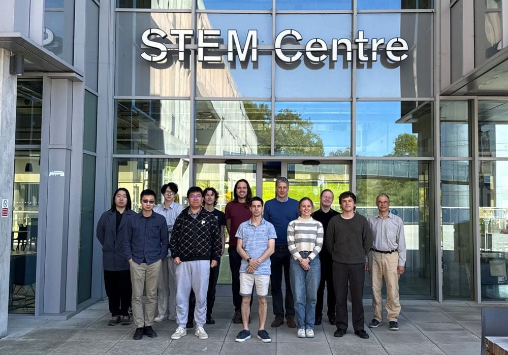 The academics and PhD students who are members of the Algebra research theme, standing outside the STEM Centre.