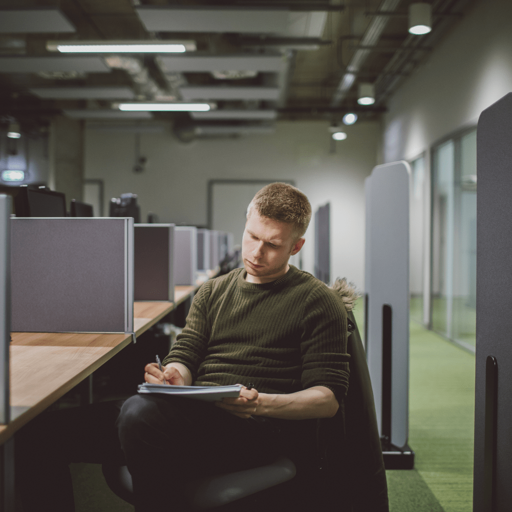 A mathematician working at a desk in the School of Mathematics, Statistics and Actuarial Science.
