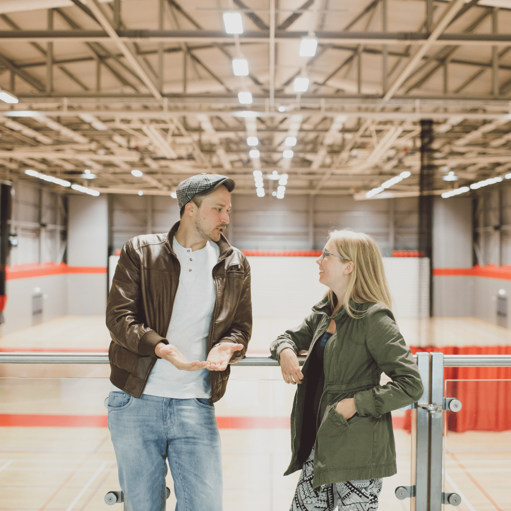 Students talking in the sports hall in the School of Sport, Rehabilitation and Exercise Sciences