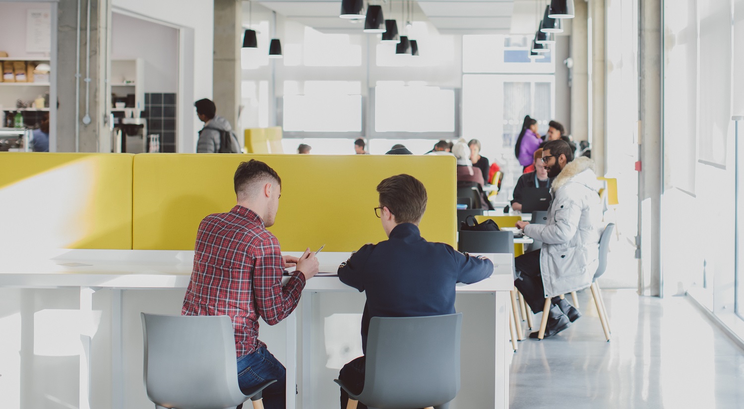 Students working at a table in Bytes cafe.