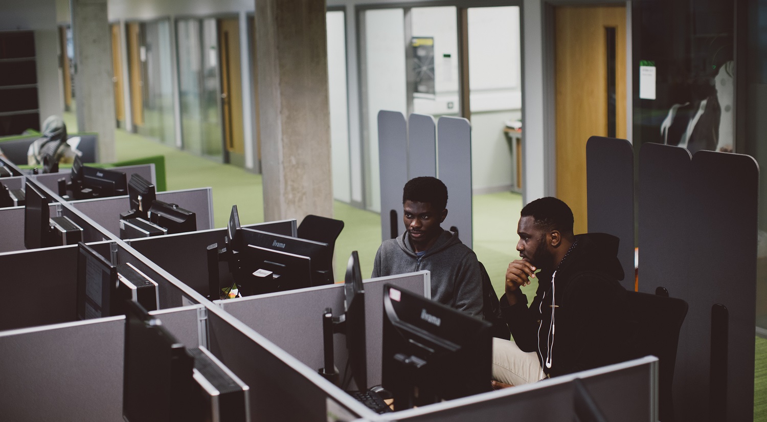 Students working at a computer in the Maths department.