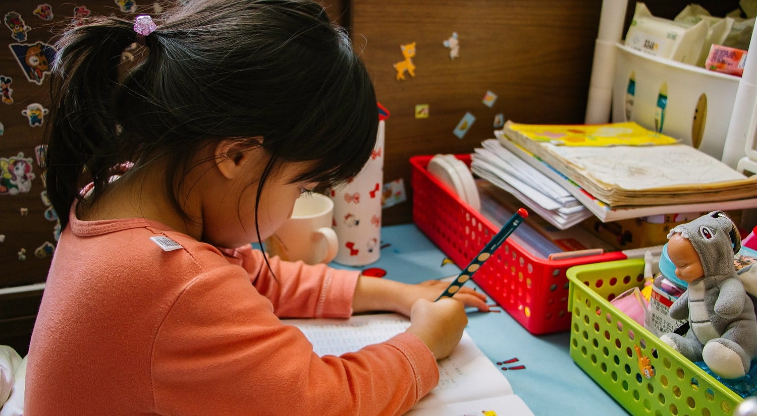 A child writing and playing, symbolising a career working with vulnerable people after completing the BA Psychodynamic Practice at Essex.