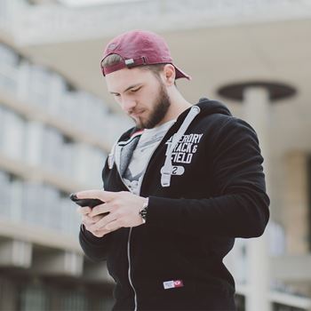 A student using his phone to contact the Department of Psychosocial and Psychoanalytic Studies at Essex.