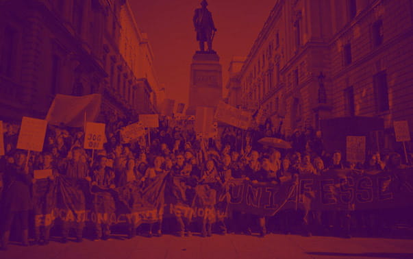 Homepage background image. University of Essex students protesting with a red and purple gradient overlay