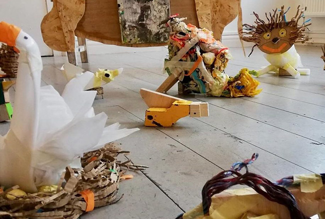 Quirky animal creations made out of everyday materials. Materials include cardboard, tissue paper and twigs. There is a few abstract animals, as well as a swan sitting on a nest.