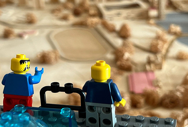 Two lego people overseeing a 3D model of the University of Essex