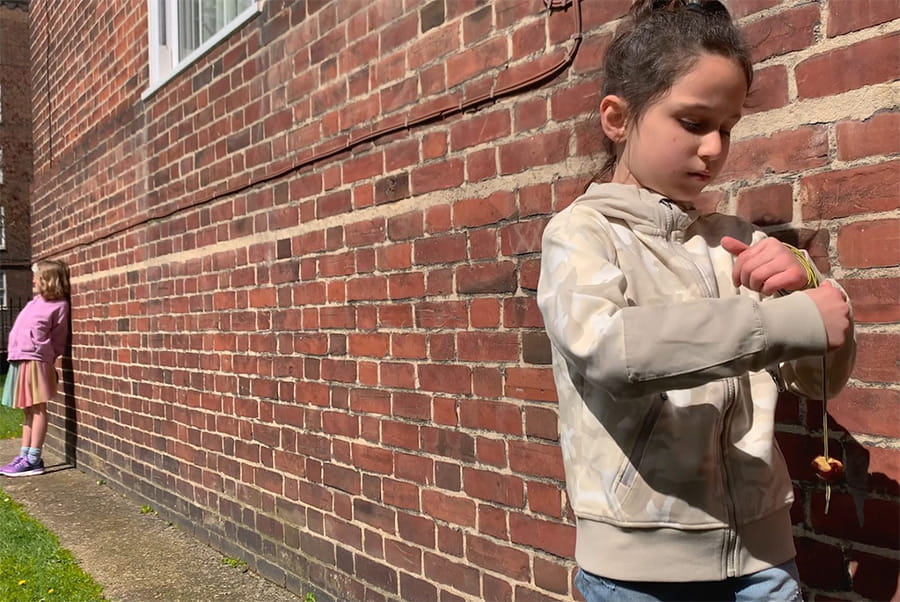 Image: Conkers, 2024. From the Children’s Games series, courtesy of Francis Alÿs and his studio. A child, standing next to a brick wall, is playing with a conker tied on a piece of string.