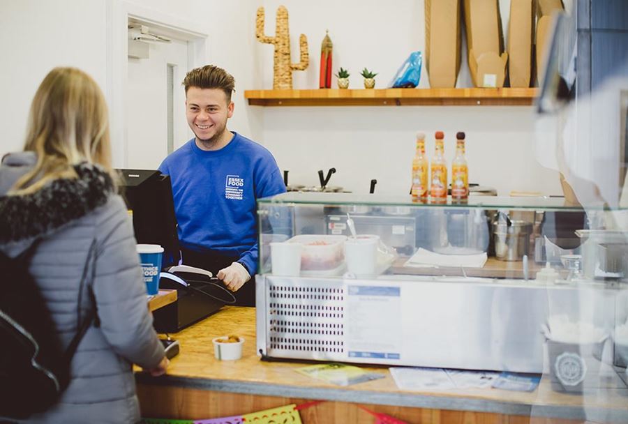 Student buying food and drink from Cantina takeaway outlet.