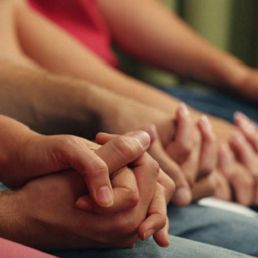 Holding hands in a counselling session