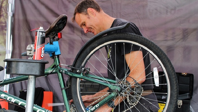 Dr Bike mechanic servicing a bike on Colchester campus