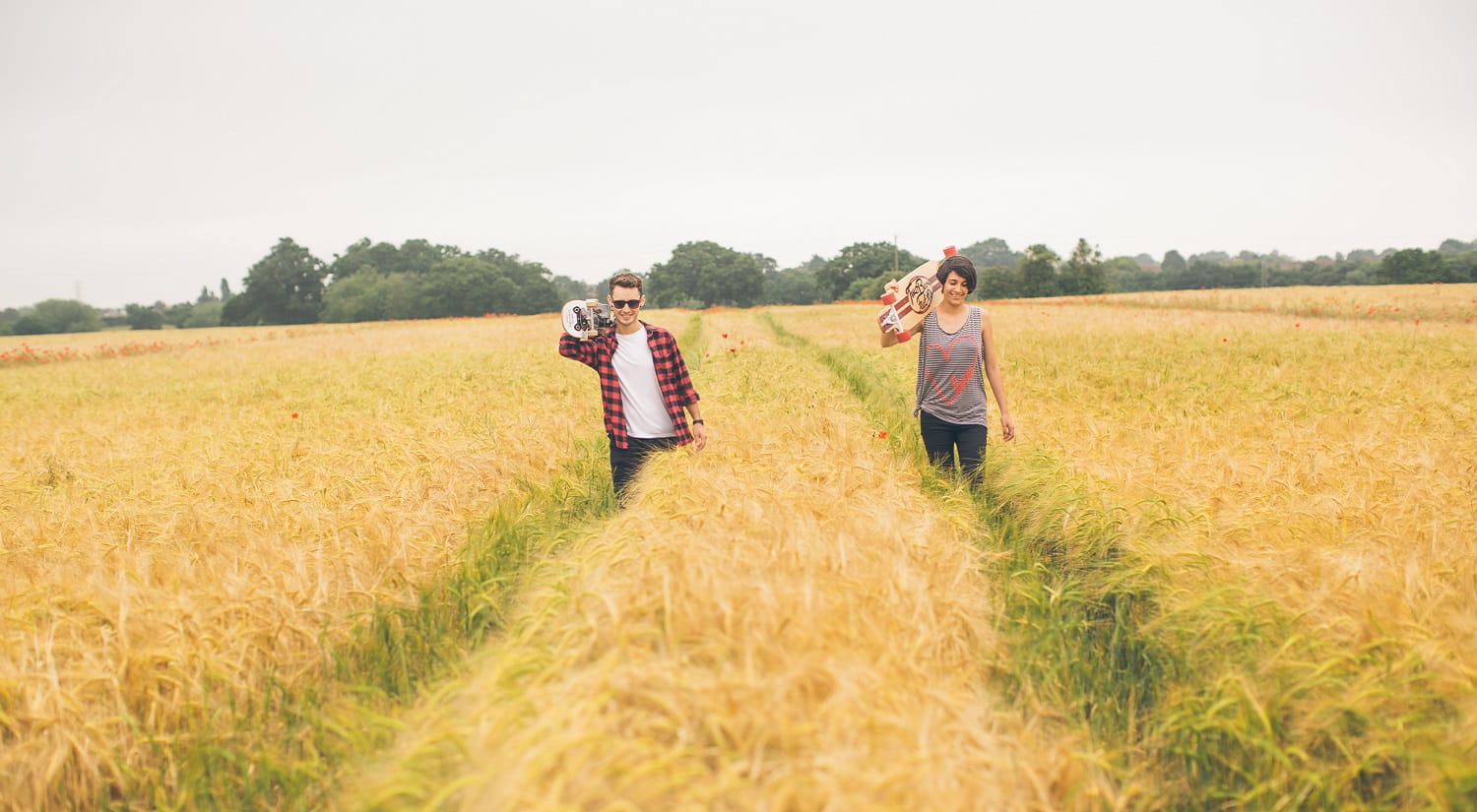 two students walking through a field