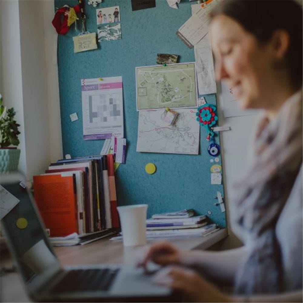 Student studying at desk in student accommodation
