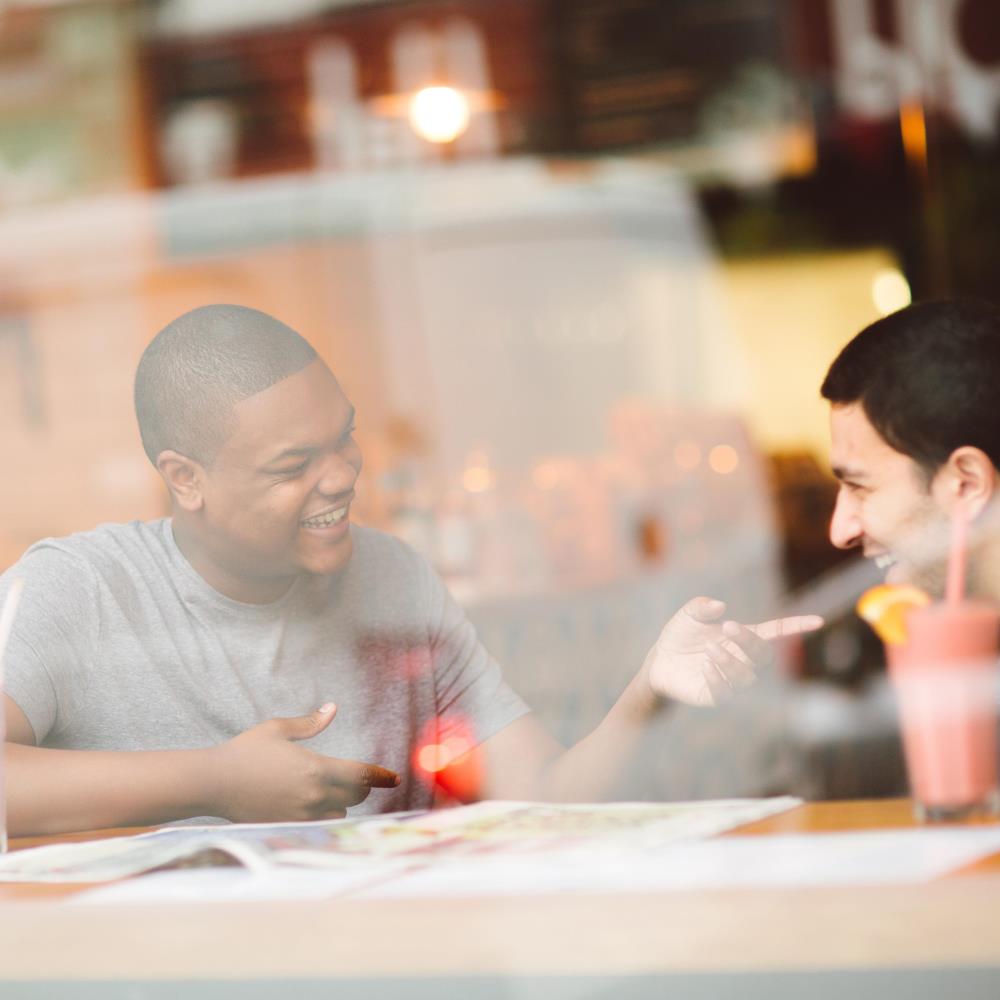 Students chatting in a cafe over a map