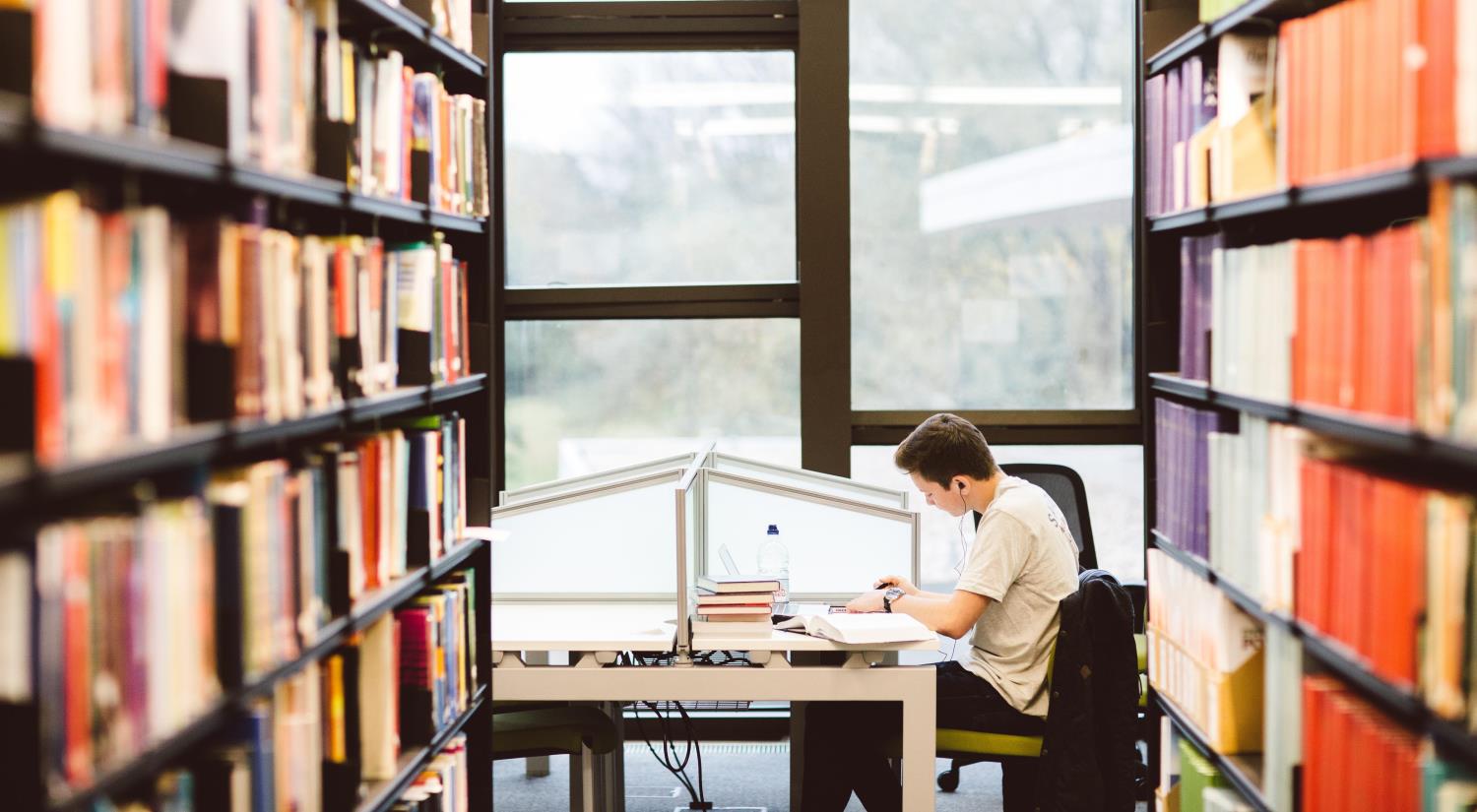 Student working at a desk in the library