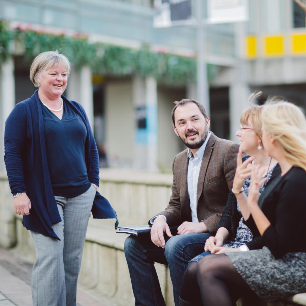 Mature students chatting in the squares
