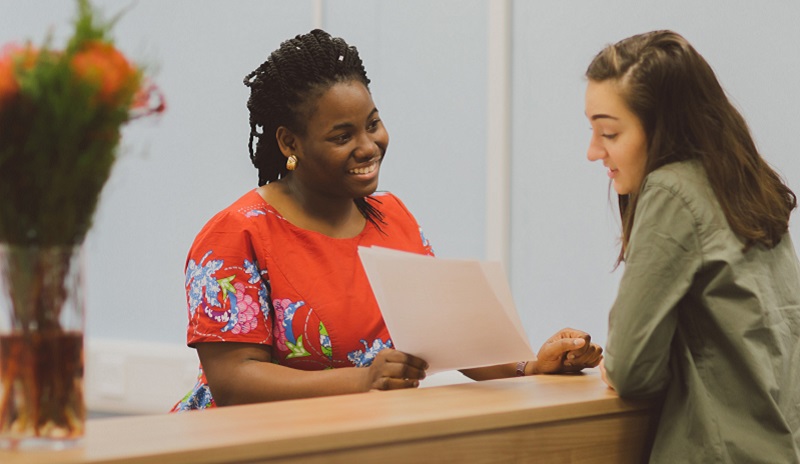 A student talking to one of our support workers in the Student Services Hub)