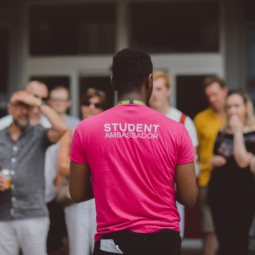 Photo of a student ambassador showing visitors around our Colchester Campus